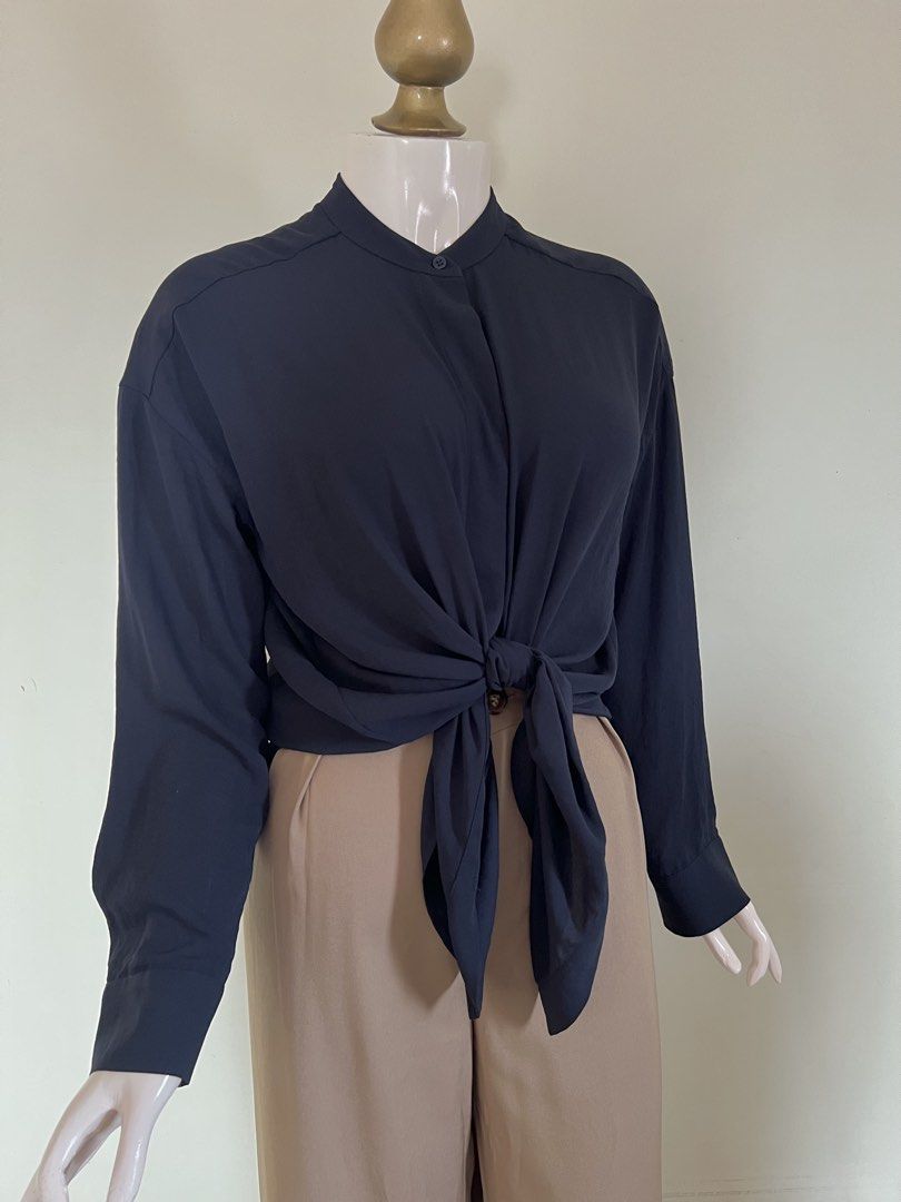 COS Navy Tie-front Blouse_ SALE (Category: Longsleeves) located in Subic. Submitted by miche.b (Listing ID 1458731619, Image 2). Description: 100% polyester mandarin style collar long sleeves with button cuffs concealed button-front closure adjustable tie-front detail relaxed fit slightly elongated fit curved hem.