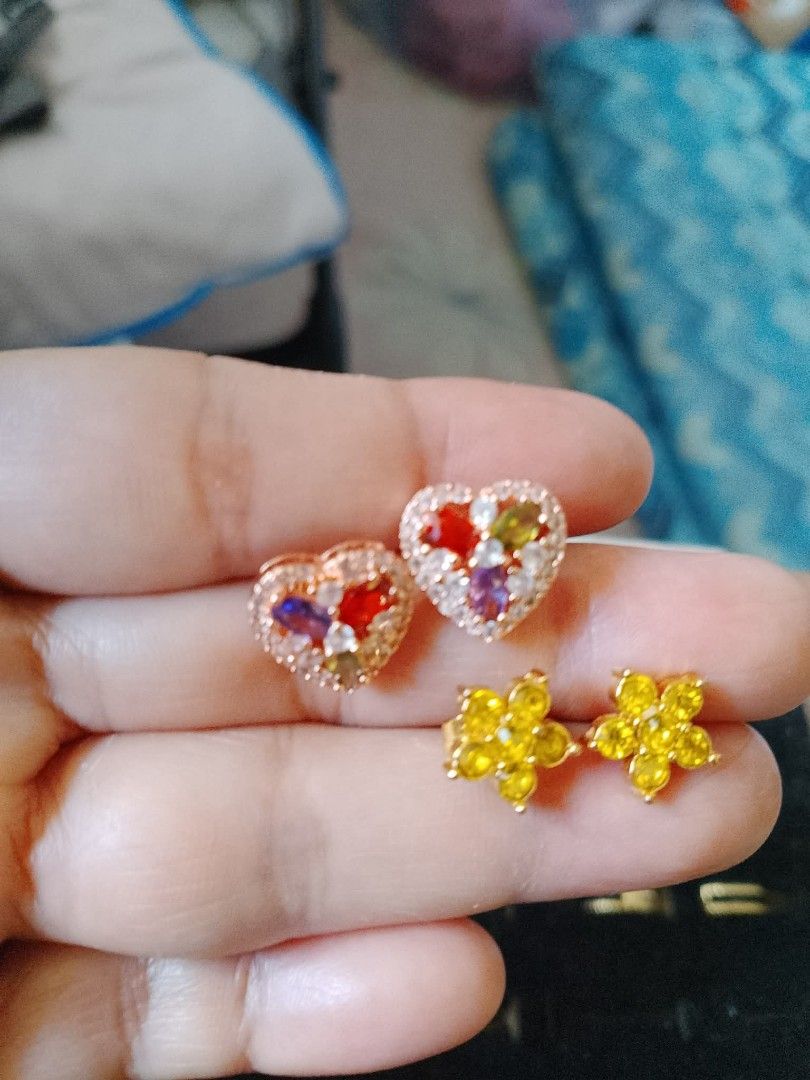 Cute Heart and Flower Stud Earrings Set (Category: Earrings) located in Cavite. Submitted by gurliegirl (Listing ID 1458781989, Image 1). Description: - Set of two cute stud earrings - One pair: Heart-shaped with colorful stones, rose gold tone - Second pair: Yellow flower-shaped with small stones - Adds a pop of color to any outfit - Ideal for everyday wear or as a fun accessory.