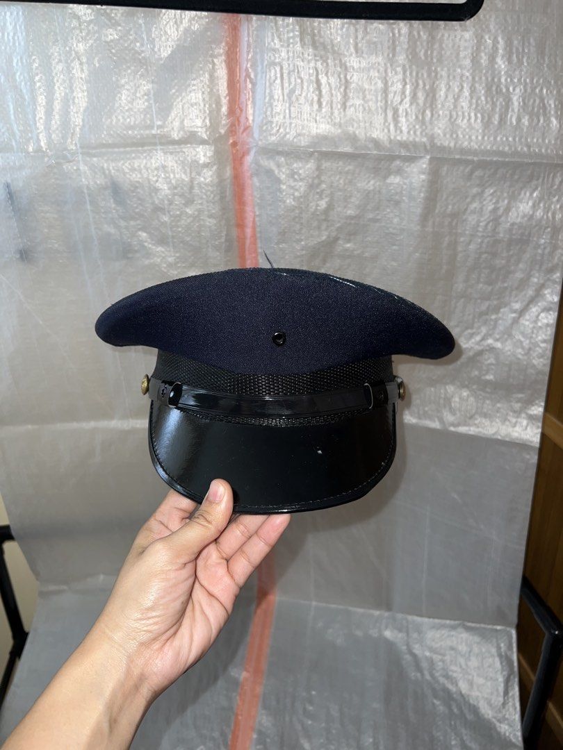 Dark Blue Security Guard Cap with Black Visor and Gold Button (Category: Caps & Hats) located in Manila. Submitted by chelseayb47224 (Listing ID 1458762177, Image 1). Description: - Dark blue Security Guard cap - Small - Used once for costume - High Quality purchased in official security personnel merchandise shop - Shiny black visor - Textured band around the base - Gold-colored button on the side - Lined interior with a mesh band - Ideal for co