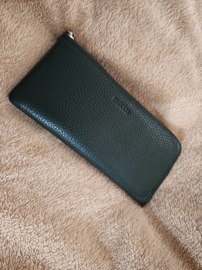 Dark Green Leather Zip Around Wallet (Category: Wallets & Card holders) located in Tanza. Submitted by declutterolshoppe (Listing ID 1458729947, Image 1). Description: - Classic dark green leather wallet - Textured leather finish - Zip-around closure (slight issue zipper) - Front zippered pocket - Multiple interior card slots and compartments - Gold-tone hardware.