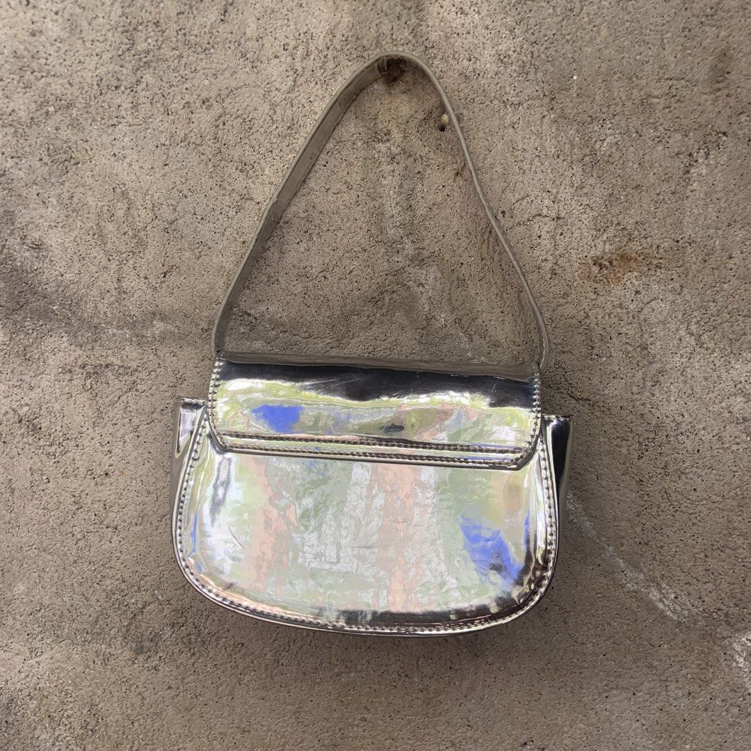 Diesel 1DR Silver Metallic Shoulder Bag with Large D Logo (Category: Luxury Bags & Wallets) located in Tabaco. Submitted by bayhust (Listing ID 1458737480, Image 3). Description: - Cool silver Diesel shoulder bag - Iconic large D logo on the front - Shiny metallic finish catches the light - Magnetic snap closure - Perfect for adding shine to any outfit - Great for nights out or making a statement.