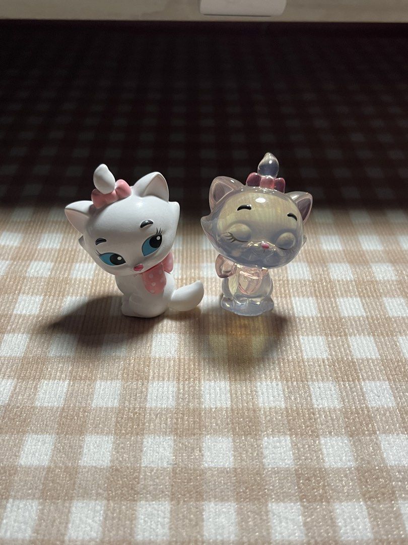 Disney Marie Cat Figurines - White & Translucent (Category: Figurines & Statues) located in Manila. Submitted by eunivrrse (Listing ID 1458791264, Image 2). Description: ‼️ 100 EACH ‼️ - Marie cat figurines from Disney's The Aristocats. - One figurine is white with a pink bow and scarf. - The second figurine is translucent with iridescent shimmers. - Both figurines feature adorable, cute poses. - Ideal for Disney collectors or fans of The Aristoc