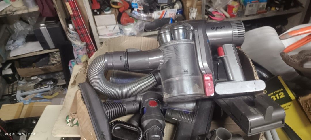Dyson Cordless Vacuum Cleaner with Accessories (Category: Vacuum Cleaner & Housekeeping) located in Makati City. Submitted by livelion_c59905 (Listing ID 1458693283, Image 3). Description: - Dyson cordless vacuum cleaner - Includes various attachments for different cleaning needs - Powerful 'Max' setting for deep cleaning - 6-cell, 2000mAh, 45Wh battery pack - Dyson Japan website and contact number visible on unit - Ideal for quick and efficient 