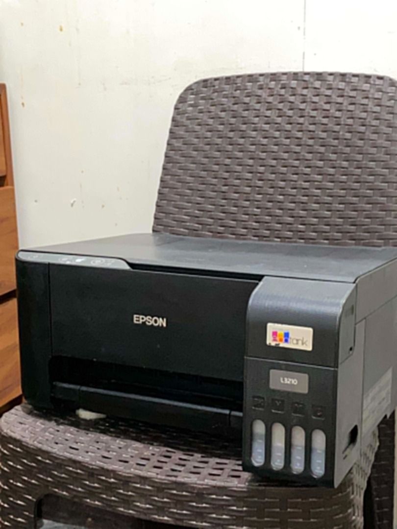 EPSON L3210 PRINTER (Category: Printers, Scanners & Copiers) located in Manila. Submitted by j.coowww (Listing ID 1458827591, Image 2). Description: Selling my Epson L3210 All-in-One Printer (Print, Scan, Copy). Includes: Complete cables, remaining ink, and a stack of A4 bond paper. Condition Note: Powers on and all functions work properly (scanner, copier, feed). However, the printed output comes out broken/gappy (putol-putol). Likely needs a si