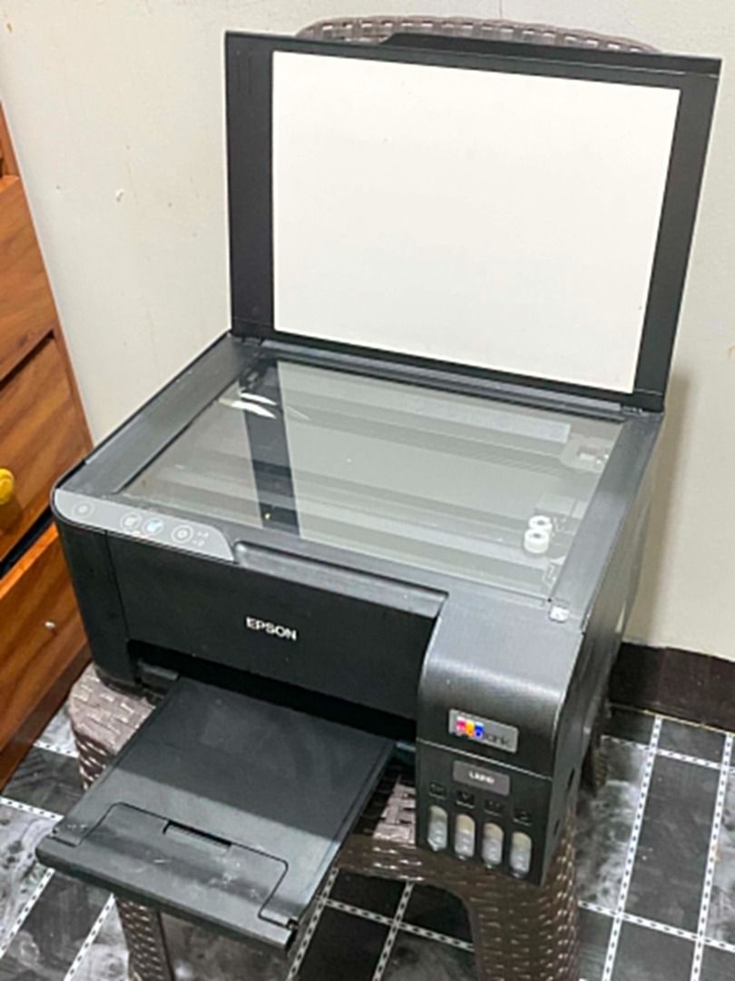 EPSON L3210 PRINTER (Category: Printers, Scanners & Copiers) located in Manila. Submitted by j.coowww (Listing ID 1458827591, Image 1). Description: Selling my Epson L3210 All-in-One Printer (Print, Scan, Copy). Includes: Complete cables, remaining ink, and a stack of A4 bond paper. Condition Note: Powers on and all functions work properly (scanner, copier, feed). However, the printed output comes out broken/gappy (putol-putol). Likely needs a si