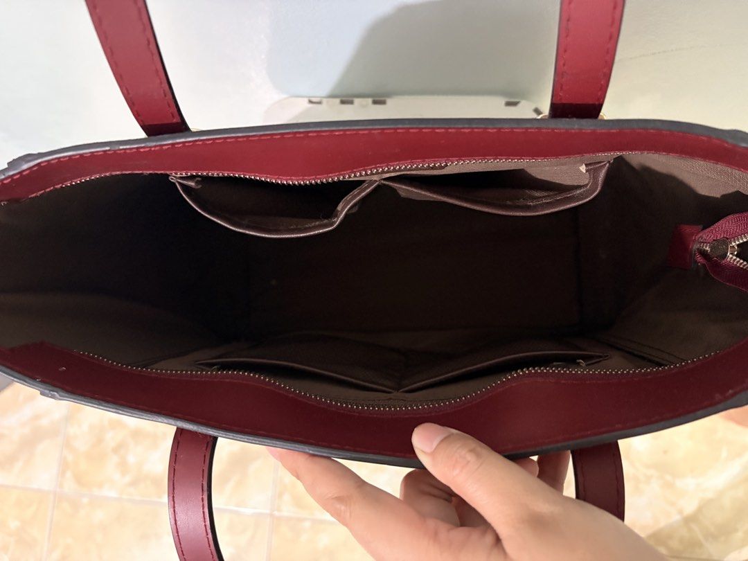 Eve & Adam Karina Tote Bag (Category: Tote Bags) located in San Pablo. Submitted by dyimmie (Listing ID 1458839690, Image 2). Description: Eve & Adam Karina Tote Bag in Burgundy Matte •Bought this 2 years ago for Php 1,600 • Didnt use it much (<5x lang) but rubber part on the handles came off thru time (mostly in storage) • Free SF for SURE buyer 🙂 • PU Leather. Stays upright even without anything inside RFS: Decluttering ++ need funds MOP: PF |