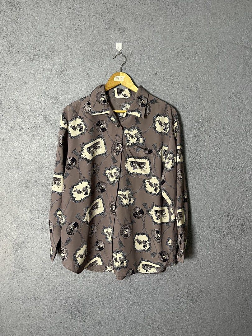 Fantaisie Vintage Button-Up Shirt (Category: Tshirts & Polo Shirts ) located in Famy. Submitted by basicthrifted (Listing ID 1458728039, Image 1). Description: - Vintage Un Brin De Fantaisie button-up shirt - Unique all-over print: frames, chains, and figures - Classic collar and button-down front - Estimated Size: F (Please check measurements) - Measurements: 28 inches (length) x 23 inches (width) - Ideal for achieving a retro aesthetic.