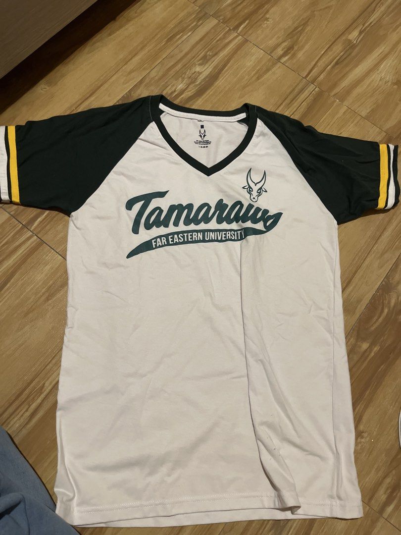 Far Eastern University Tamaraws Baseball Tee (Category: Tshirts & Polo Shirts ) located in Manila. Submitted by gbrxql (Listing ID 1458828539, Image 1). Description: - FEU Tamaraws baseball tee - White body with dark green raglan sleeves - Yellow and white stripes on sleeve cuffs - Ideal for showing school pride - Comfortable for everyday wear.
