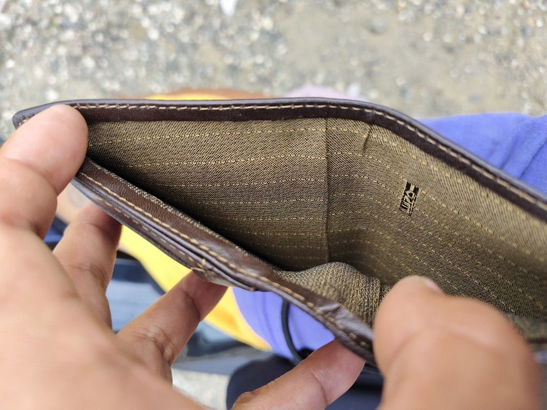 Fendi Zucca Monogram Bifold Wallet (Category: Luxury Bags & Wallets) located in Tagbilaran City. Submitted by bossjepoy (Listing ID 1458726473, Image 2). Description: - Authentic Fendi wallet - Classic brown & black Zucca monogram pattern - Genuine leather trim - Interior zippered coin pocket - Shows some signs of wear (leather & lining), but plenty of life left - Perfect for Fendi collectors.