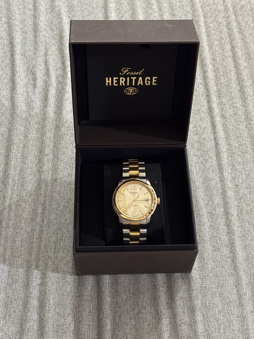 Fossil Heritage Automatic Watch Two-Tone Stainless Steel (Category: Men's Watches) located in Santo Tomas. Submitted by kencrngl (Listing ID 1458693722, Image 1). Description: - Fossil Heritage Automatic Watch - Two-tone stainless steel band (gold and silver) - See the automatic movement through the case back - Water resistant up to 5 ATM - Model: ME3228 -38mm - Comes with original Fossil Heritage box.
