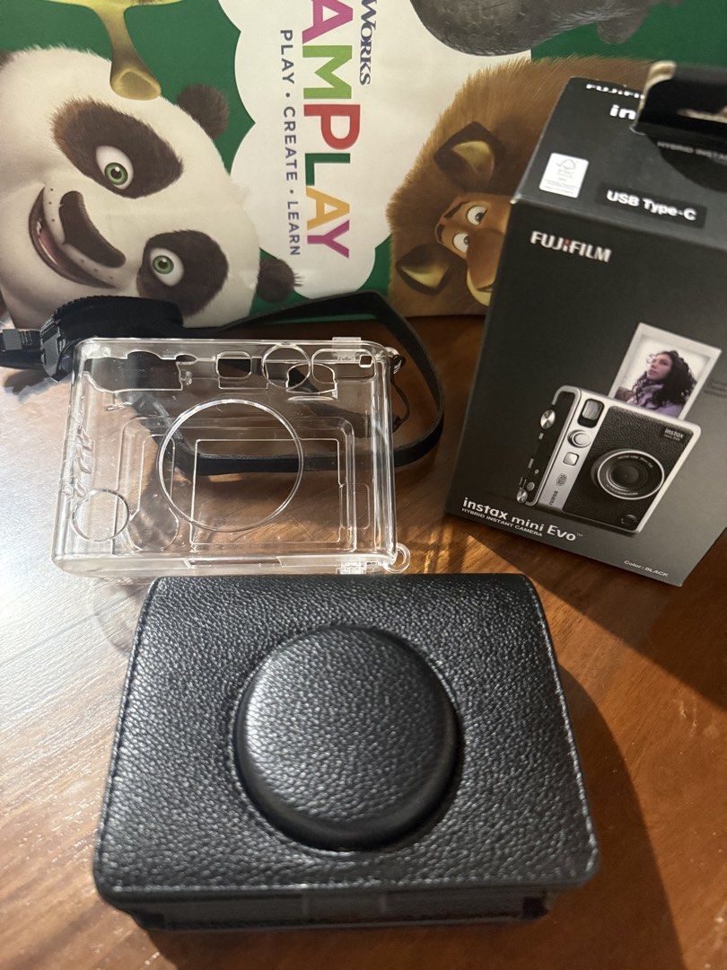 Fujifilm Instax Mini Evo Hybrid Instant Camera (Category: Cameras) located in Pateros City. Submitted by superroxy (Listing ID 1458700167, Image 2). Description: - Fujifilm Instax Mini Evo Hybrid Camera - Comes with Original Box - Includes Clear Protective Case - Includes Black Leather Case - Ideal for both instant prints and digital photos - In excellent working condition.