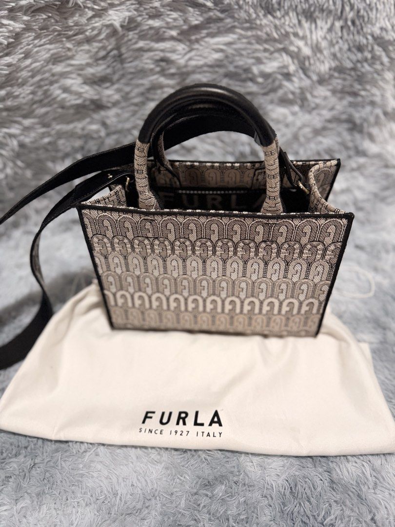 Furla Tote Bag with Monogram Print (Category: Luxury Bags & Wallets) located in Taguig. Submitted by ljlucero (Listing ID 1458697257, Image 1). Description: - Authentic Furla tote bag - Signature Furla monogram print all over - Black leather handles and strap - Comes with original dust bag - Spacious interior, ideal for everyday use or weekend getaways.