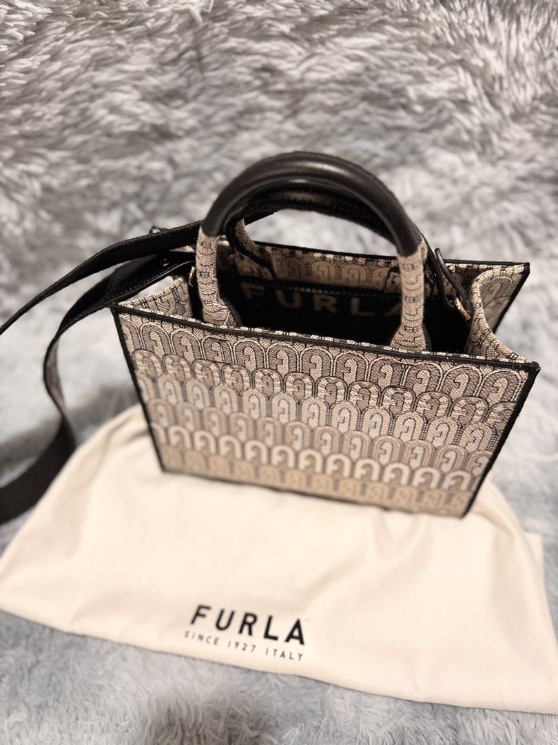 Furla Tote Bag with Monogram Print (Category: Luxury Bags & Wallets) located in Taguig. Submitted by ljlucero (Listing ID 1458697257, Image 3). Description: - Authentic Furla tote bag - Signature Furla monogram print all over - Black leather handles and strap - Comes with original dust bag - Spacious interior, ideal for everyday use or weekend getaways.