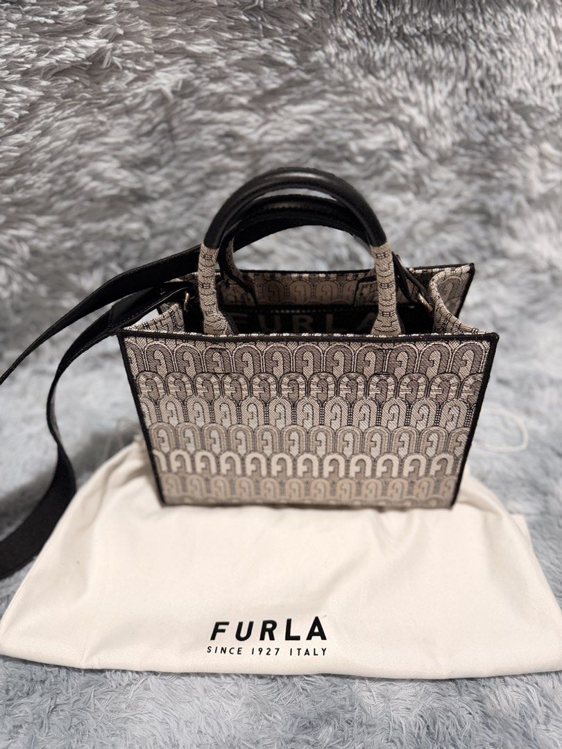 Furla Tote Bag with Monogram Print (Category: Luxury Bags & Wallets) located in Taguig. Submitted by ljlucero (Listing ID 1458697257, Image 2). Description: - Authentic Furla tote bag - Signature Furla monogram print all over - Black leather handles and strap - Comes with original dust bag - Spacious interior, ideal for everyday use or weekend getaways.