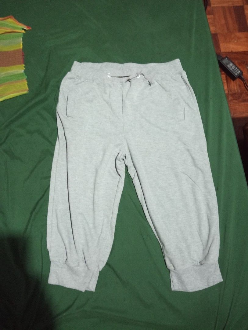 Grey Cropped Sweatpants with Drawstring Waist (Category: Shorts) located in Quezon City. Submitted by taba0912 (Listing ID 1458778958, Image 1). Description: - Comfortable grey cropped sweatpants - Elastic waistband with drawstring for adjustable fit - Two convenient side pockets - Cuffed ankles for a snug feel - Ideal for lounging at home or casual wear.