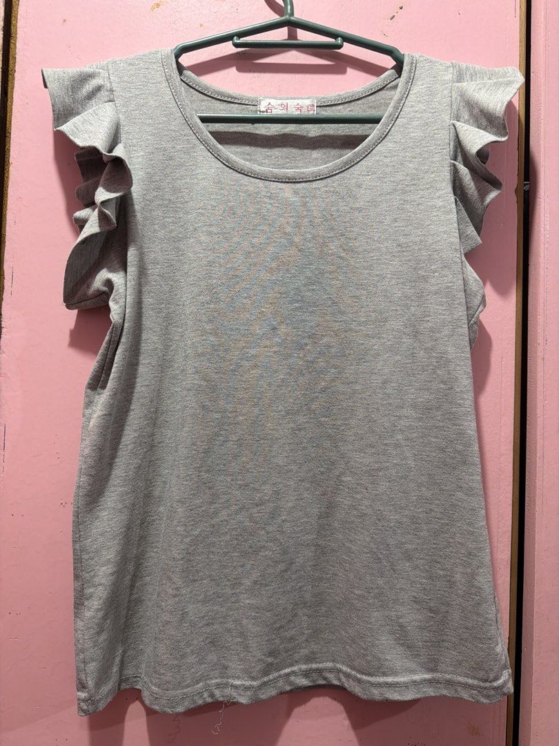 Grey T-shirt with Ruffle Sleeves (Category: Blouses) located in Muntinlupa City. Submitted by lybns (Listing ID 1458806796, Image 1). Description: - Grey t-shirt - Cute ruffle sleeves - Simple and comfy design - Soft fabric - Ideal for casual wear - Versatile, easy to pair with any outfit.