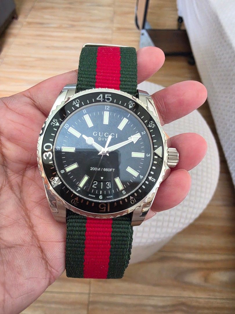 Gucci Dive Watch Black Dial Green Red Strap (Category: Luxury Watches) located in Quezon City. Submitted by deng43763 (Listing ID 1458701594, Image 1). Description: - Gucci Dive Watch - Black Dial - Iconic Green and Red Stripe NATO Strap - Water Resistant 200m/660ft - Original Gucci Box and Packaging Included - Suitable for everyday wear or diving.