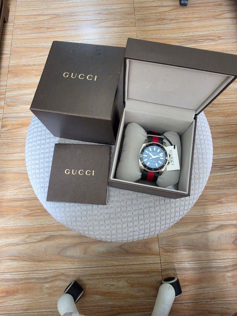 Gucci Dive Watch Black Dial Green Red Strap (Category: Luxury Watches) located in Quezon City. Submitted by deng43763 (Listing ID 1458701594, Image 2). Description: - Gucci Dive Watch - Black Dial - Iconic Green and Red Stripe NATO Strap - Water Resistant 200m/660ft - Original Gucci Box and Packaging Included - Suitable for everyday wear or diving.