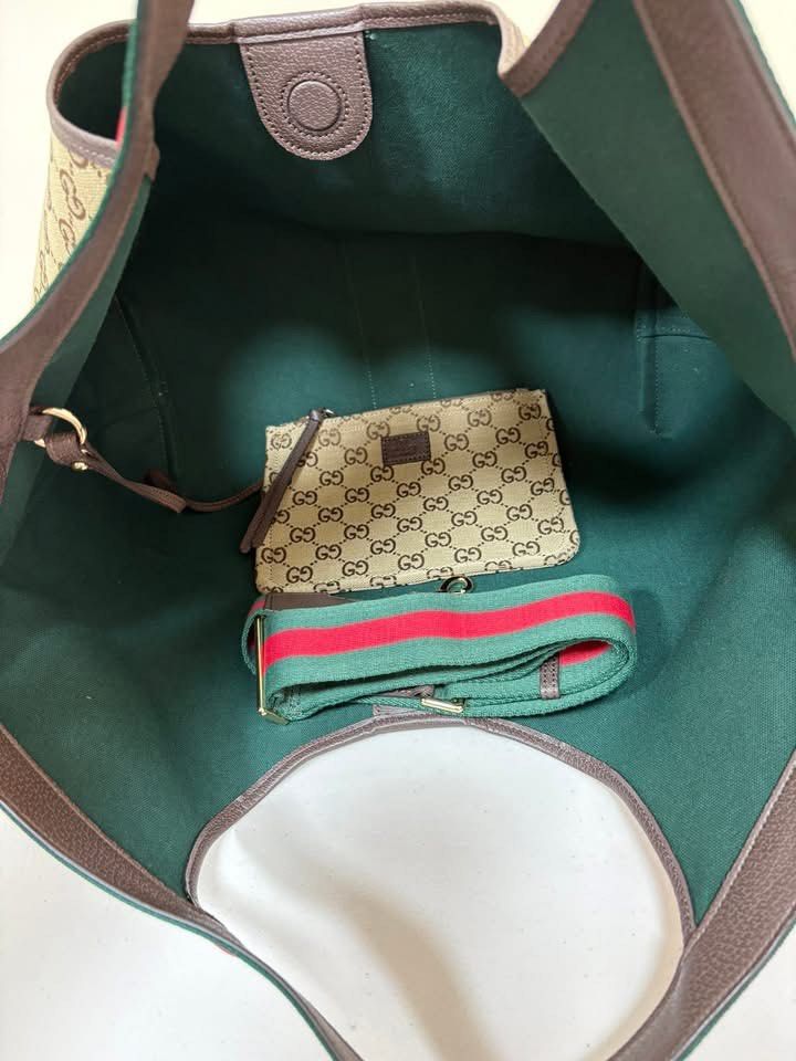 Gucci Monogram Canvas Tote Bag with Pouch (Category: Luxury Bags & Wallets) located in Los Banos. Submitted by ukaynidizkie (Listing ID 1458824236, Image 3). Description: - Gucci tote bag - Beige monogram canvas with signature green and red stripe - Comes with a matching pouch - Dark green interior - Leather trim and handles - Great everyday bag .