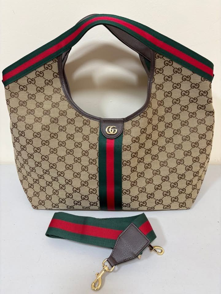 Gucci Monogram Canvas Tote Bag with Pouch (Category: Luxury Bags & Wallets) located in Los Banos. Submitted by ukaynidizkie (Listing ID 1458824236, Image 2). Description: - Gucci tote bag - Beige monogram canvas with signature green and red stripe - Comes with a matching pouch - Dark green interior - Leather trim and handles - Great everyday bag .