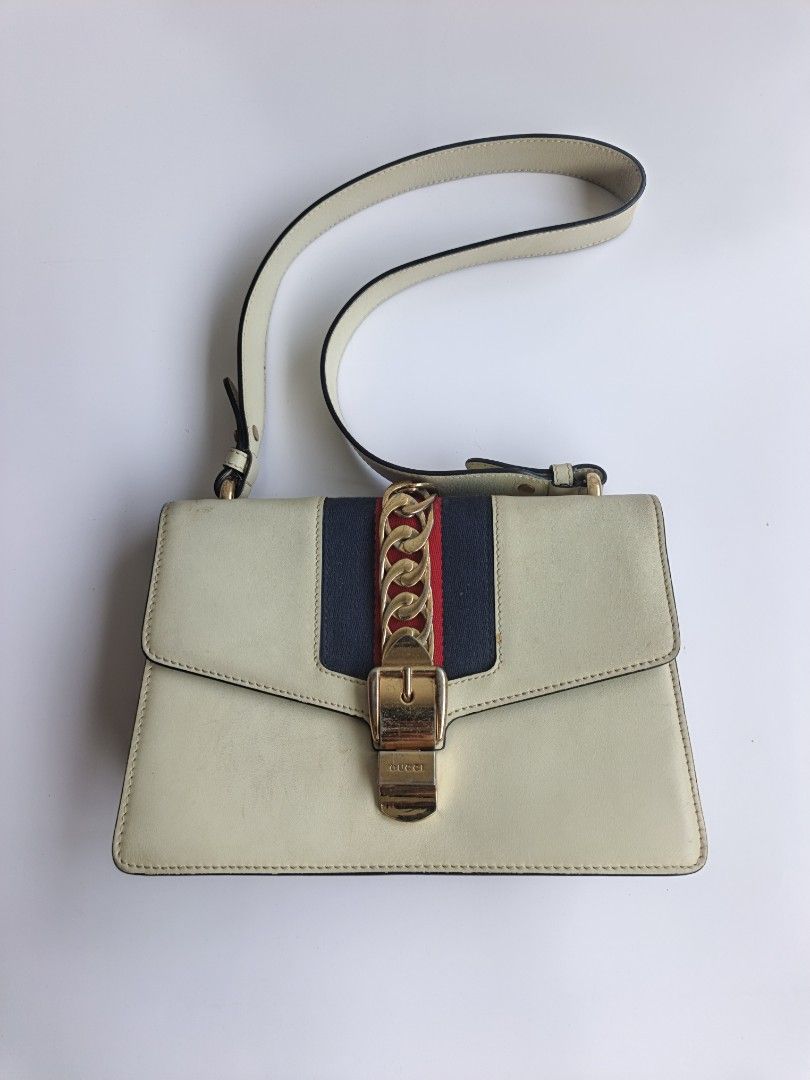 Gucci Sylvie Leather Shoulder Bag Cream (Category: Luxury Bags & Wallets) located in Cavite. Submitted by benta_bounce (Listing ID 1458785747, Image 1). Description: - Cream Leather Gucci Bag - Features iconic Sylvie Web Stripe - Signature Chain Detail - Gold Hardware - Minor signs of wear on leather and hardware (as pictured) - Comes with detachable shoulder strap - A classic, timeless piece.