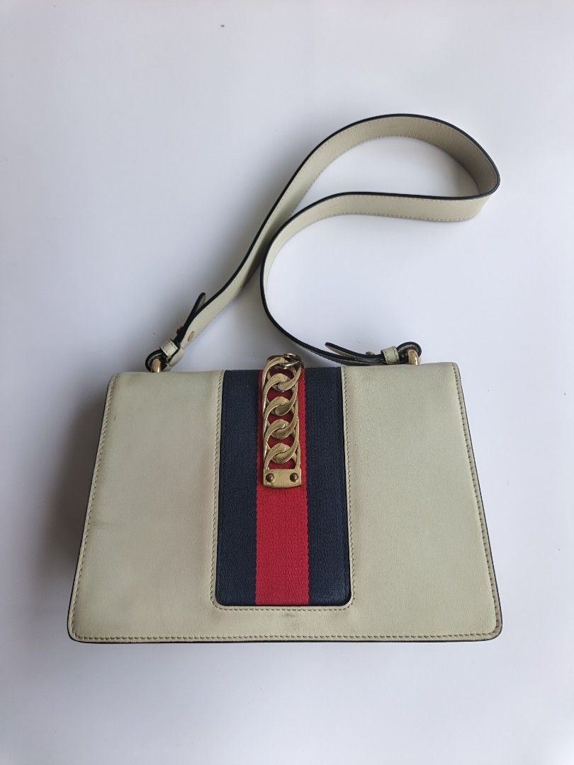 Gucci Sylvie Leather Shoulder Bag Cream (Category: Luxury Bags & Wallets) located in Cavite. Submitted by benta_bounce (Listing ID 1458785747, Image 2). Description: - Cream Leather Gucci Bag - Features iconic Sylvie Web Stripe - Signature Chain Detail - Gold Hardware - Minor signs of wear on leather and hardware (as pictured) - Comes with detachable shoulder strap - A classic, timeless piece.
