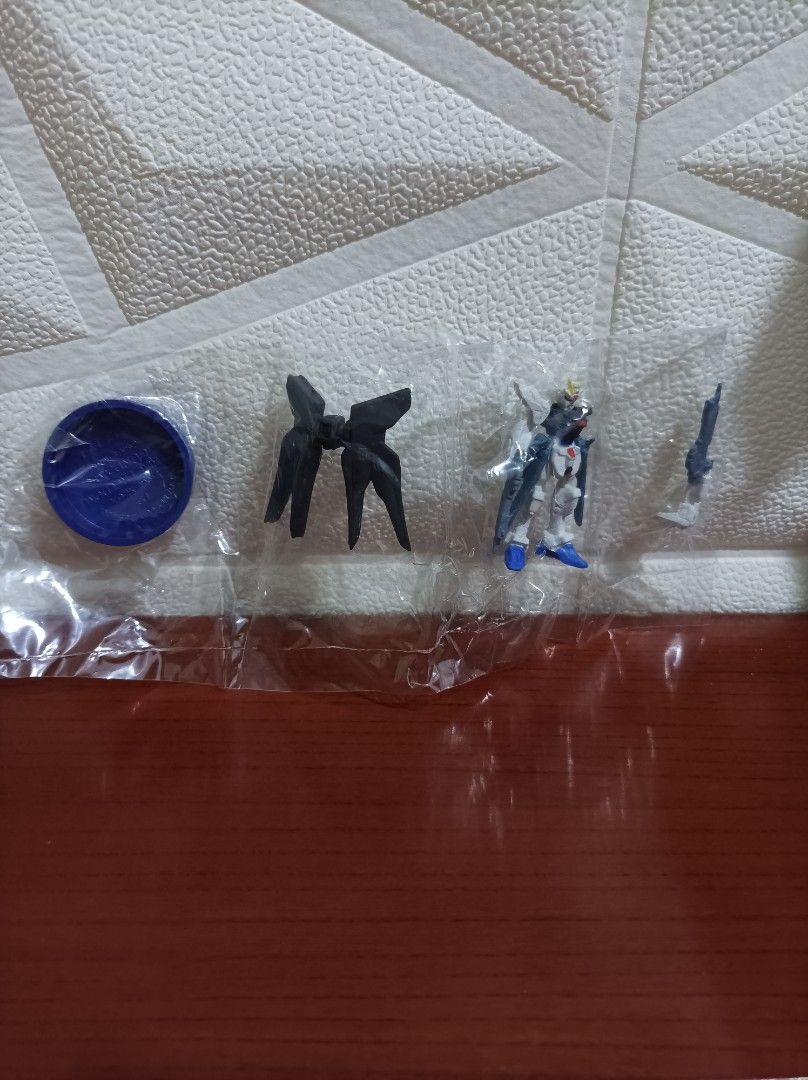 Gundam Mini Figure Set with Accessories (Category: Gundam & Model Kits) located in Bacoor. Submitted by kuroochiii94695 (Listing ID 1458725722, Image 1). Description: - Includes: Mini Gundam mobile suit, backpack accessory, weapon, and blue display base. - Condition: All items are individually bagged. - Ideal for: Gundam collectors and display enthusiasts..