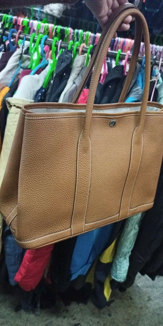 Hermes Garden Party Tote Bag (Category: Luxury Bags & Wallets) located in Baguio. Submitted by XycerlynCLXN (Listing ID 1458802703, Image 1). Description: - Classic Hermes tote bag - Brown pebbled leather exterior with contrasting stitching - Canvas interior with a zippered pocket - Spacious main compartment - Comfortable shoulder straps for everyday wear - Ideal for carrying essentials.