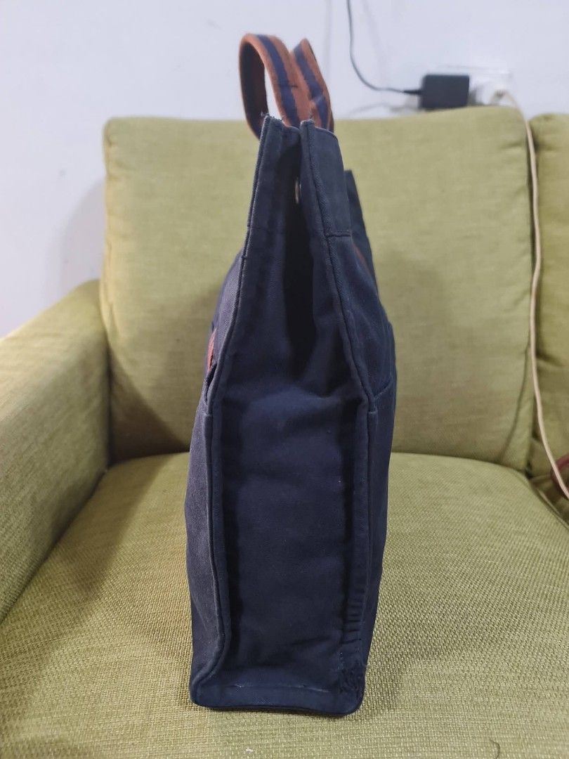 Hermes Paris Navy Canvas Tote Bag (Category: Luxury Bags & Wallets) located in Paombong. Submitted by dosbagshop (Listing ID 1458757870, Image 3). Description: - Authentic - Classic navy canvas tote from Hermes Paris - Features iconic striped handles - Ample interior space - Convenient exterior pockets - Ideal for everyday use or travel - A timeless and versatile accessory.