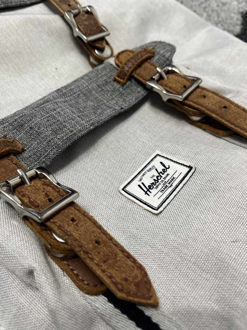 Herschel Supply Co. Backpack - Grey and White (Category: Backpacks) located in Paranaque City. Submitted by rowell.nono (Listing ID 1458771360, Image 2). Description: * Brand: Herschel Supply Co. * Model: Little America * Color: Gray/Grey Crosshatch + Tan * Capacity: around 23–25L for the older version * Laptop compartment: padded/fleece-lined, approximately 15”–17” depending on the generation * Closure: drawcord + magnetic/pin buckle straps * Fr