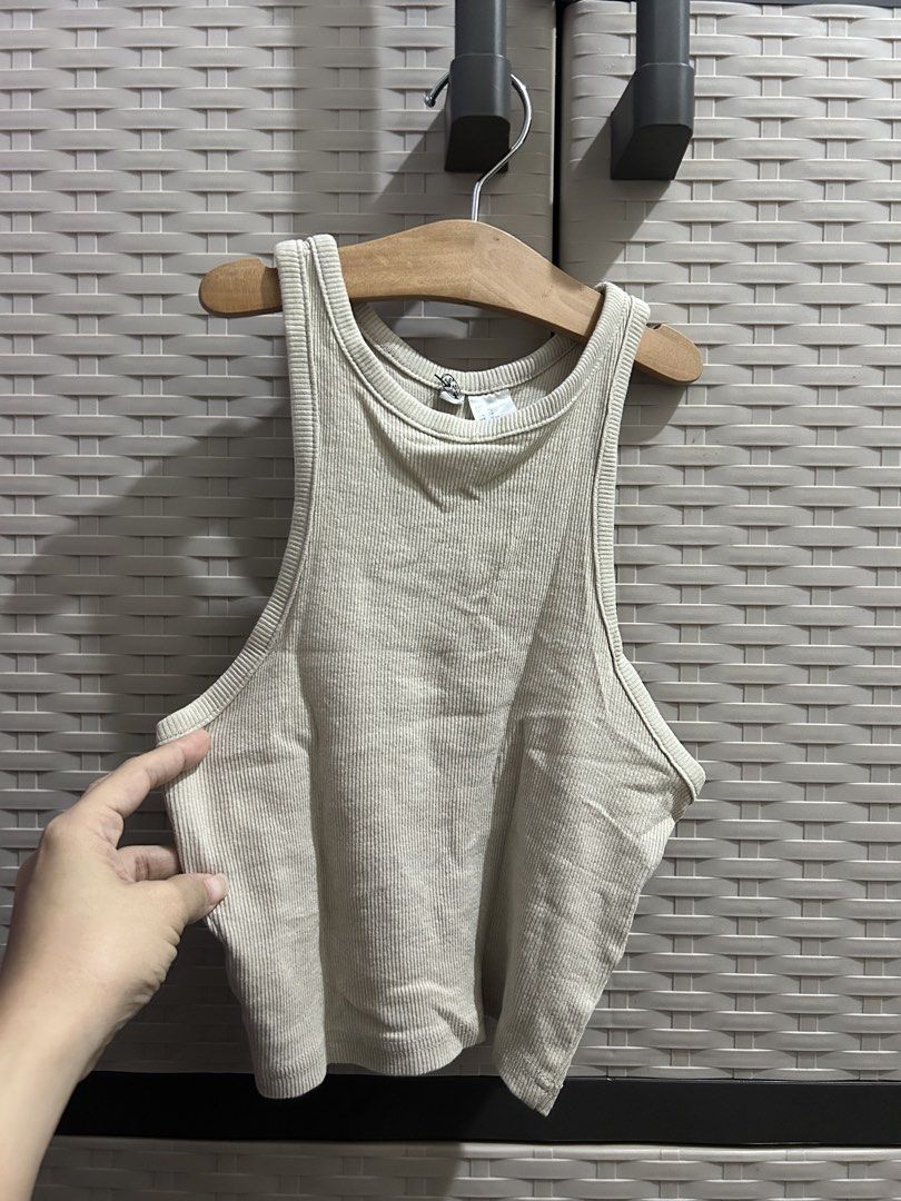 H&M Ribbed Tank Top Beige (Category: Sleeveless) located in San Jose. Submitted by abbsc. (Listing ID 1458690471, Image 1). Description: - Basic ribbed tank top from H&M - Neutral beige color - Racerback style - Stretchy and comfortable material - Versatile for layering or wearing on its own - Easy to pair with any outfit.