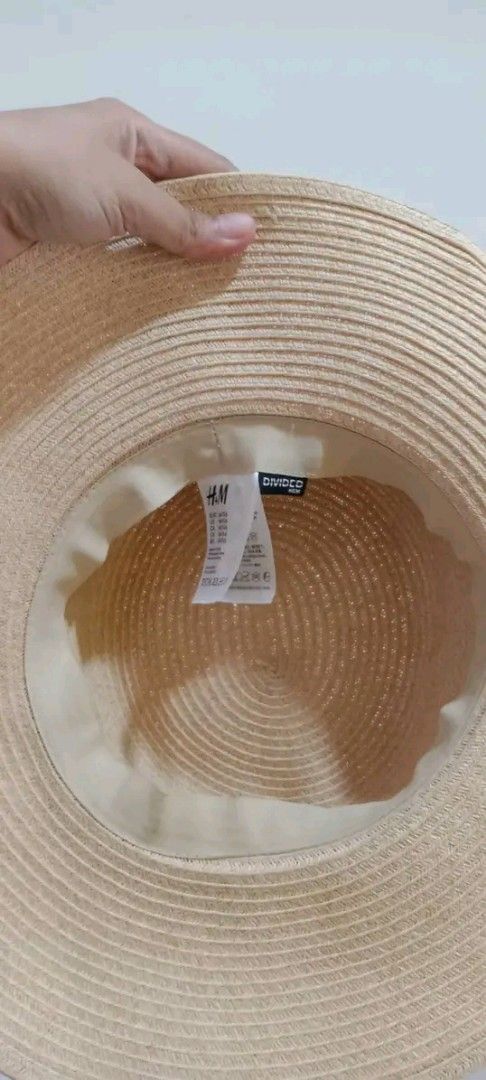H&M Straw Hat with Black Ribbon (Category: Hats & Beanies) located in Gapan. Submitted by montesnora80204 (Listing ID 1458781109, Image 3). Description: - Wide brim straw hat from H&M - Natural straw color with a black ribbon band - Ideal for sunny days and outdoor activities - Provides sun protection - Lightweight and easy to pack for travel - Versatile for beach trips or casual outfits.