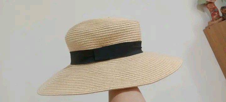 H&M Straw Hat with Black Ribbon (Category: Hats & Beanies) located in Gapan. Submitted by montesnora80204 (Listing ID 1458781109, Image 1). Description: - Wide brim straw hat from H&M - Natural straw color with a black ribbon band - Ideal for sunny days and outdoor activities - Provides sun protection - Lightweight and easy to pack for travel - Versatile for beach trips or casual outfits.