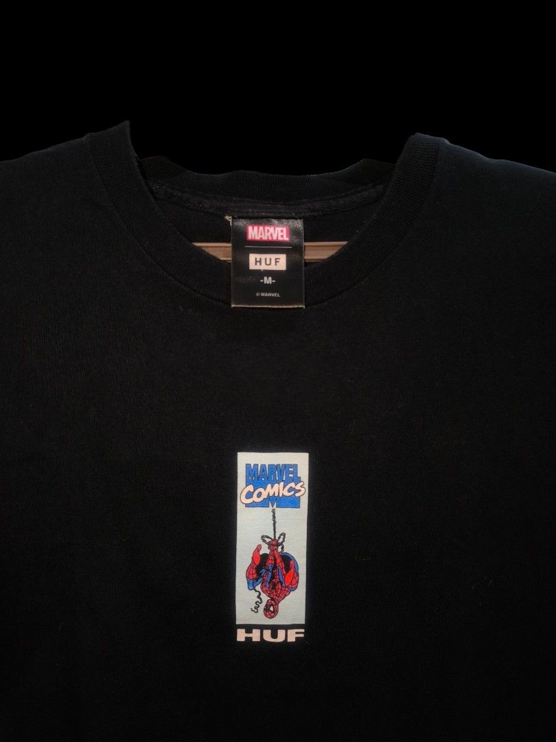 HUF Marvel Spider-Man T-Shirt SALE/SWAP (Category: Tshirts & Polo Shirts ) located in Muntinlupa City. Submitted by narymadine_ (Listing ID 1431278433, Image 1). Description: Black HUF t-shirt featuring a Spider-Man graphic on the front and back. The shirt has a Marvel Comics logo on the tag. It is a size medium. The shirt has a crew neck and short sleeves. The graphic on the front shows Spider-Man swinging. The back graphic shows a different Spi