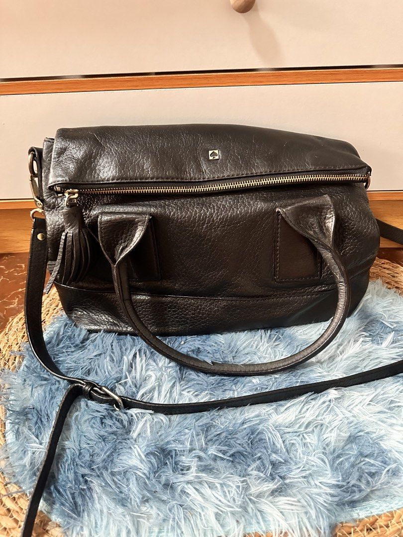 Kate Spade (Category: Cross-body Bags) located in Quezon City. Submitted by kerlitops (Listing ID 1458758365, Image 1). Description: - Brand: Kate Spade - Color: Black - Material: Pebbled Leather - Style: Crossbody Bag - Features: Top handles, adjustable crossbody strap, classic striped interior lining.