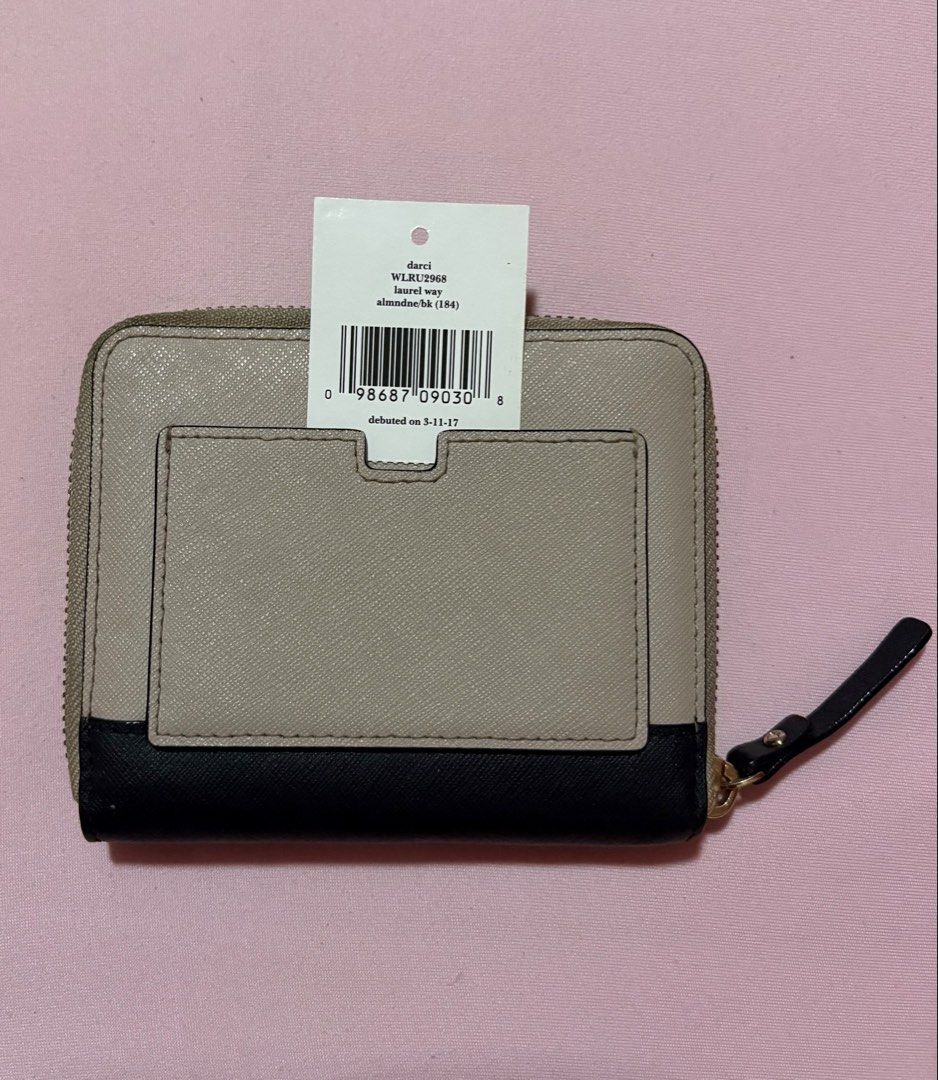 Kate Spade Authentic Wallet Almond/Black (Category: Wallets & Card holders) located in Paranaque City. Submitted by petite.arch1ve (Listing ID 1458765793, Image 2). Description: - 100% Authentic Kate Spade Darci Wallet - Color: Almond and Black - Material: Saffiano Leather - Closure: Zip-around - Interior: Card slots and zip pocket - Includes: Original tag - Debut Date: 5-11-17 - Model Number: WL2RU2968 - Like new, well taken care of - DM me for 