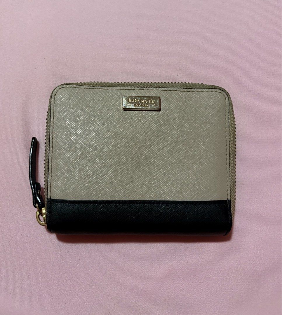 Kate Spade Authentic Wallet Almond/Black (Category: Wallets & Card holders) located in Paranaque City. Submitted by petite.arch1ve (Listing ID 1458765793, Image 1). Description: - 100% Authentic Kate Spade Darci Wallet - Color: Almond and Black - Material: Saffiano Leather - Closure: Zip-around - Interior: Card slots and zip pocket - Includes: Original tag - Debut Date: 5-11-17 - Model Number: WL2RU2968 - Like new, well taken care of - DM me for 