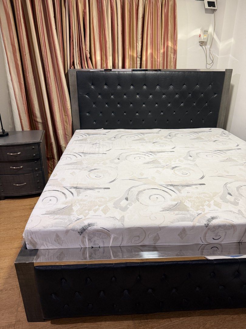 King Size Tufted Bed Frame with Matching Nightstand (Category: Bed Frames & Mattresses) located in Paranaque City. Submitted by captainthanos01 (Listing ID 1458830204, Image 2). Description: - Queen size bed frame - Tufted headboard upholstered in black faux leather - Modern grey wood finish frame - Includes matching 3-drawer nightstand - Nightstand has distressed grey finish and metal hardware - Great set for any bedroom.