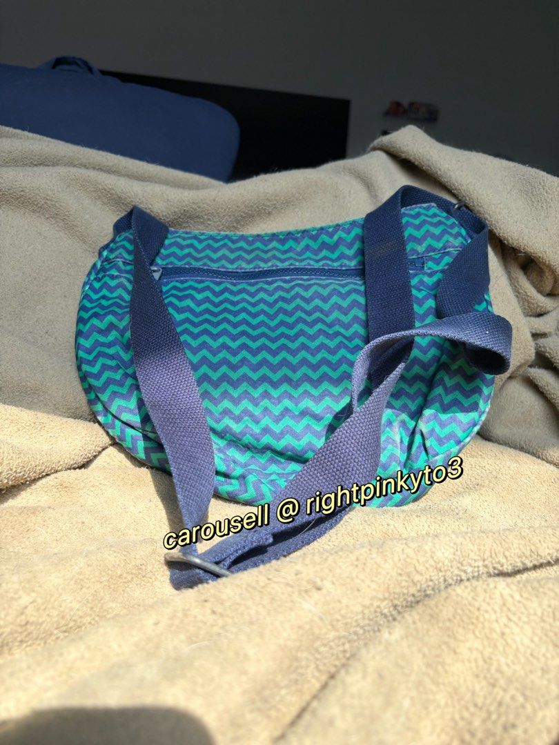 Kipling Zigzag Pattern Crossbody Bag (Category: Cross-body Bags) located in Davao. Submitted by rightpinkyto3 (Listing ID 1458691618, Image 2). Description: Cool zigzag Kipling crossbody bag in blue and green. Features front and main zip pockets, inner pockets, and adjustable strap. Perfect for daily use. Some wear on the leather parts and rust..