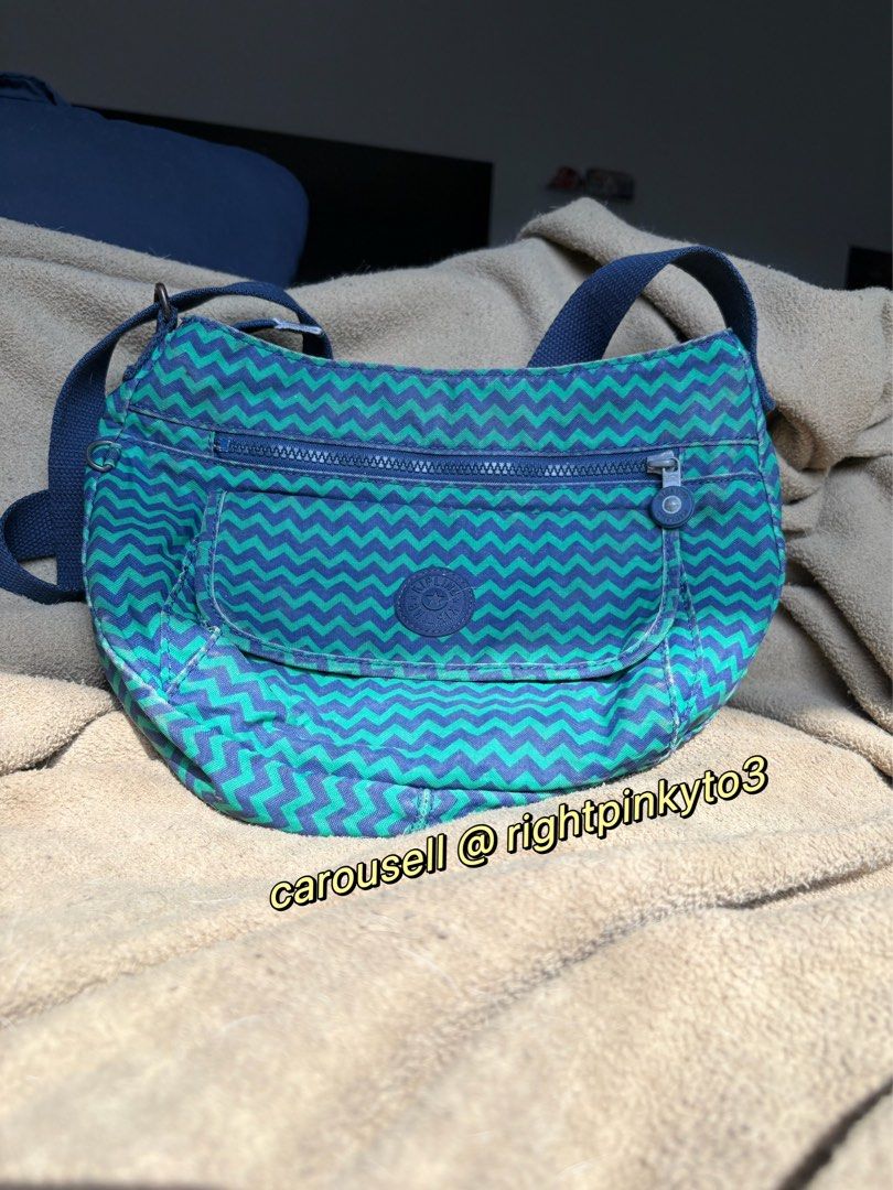 Kipling Zigzag Pattern Crossbody Bag (Category: Cross-body Bags) located in Davao. Submitted by rightpinkyto3 (Listing ID 1458691618, Image 1). Description: Cool zigzag Kipling crossbody bag in blue and green. Features front and main zip pockets, inner pockets, and adjustable strap. Perfect for daily use. Some wear on the leather parts and rust..