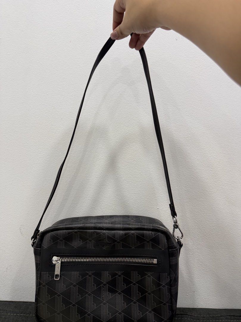 Lacoste Monogram Crossbody Bag Black (Category: Shoulder Bags) located in Manila. Submitted by ejamescatorce (Listing ID 1458690623, Image 2). Description: - Authentic Lacoste Zely vanity bag - unisex -Bought in Lacoste Rob Mag -No issue.