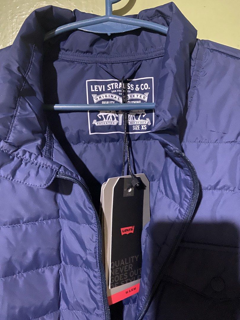 Levi Strauss & Co. Navy Puffer Jacket (Category: Coats, Jackets and Outerwear) located in Tarlac. Submitted by pangz0918 (Listing ID 1458819000, Image 2). Description: - Levi Strauss & Co. navy blue puffer jacket - Lightweight and warm - Zip-up front - Chest pocket - Size XS (small to medium size for woman) - Ideal for layering or standalone wear.