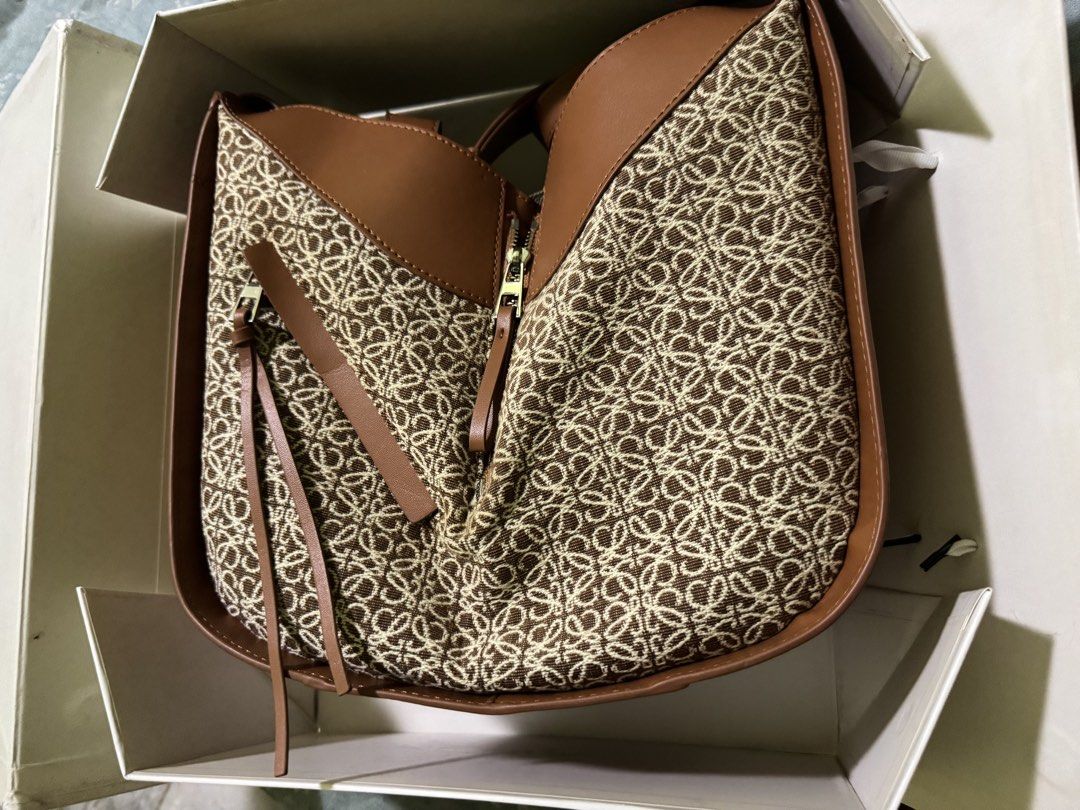 Loewe Anagram Hammock Bag Brown Canvas Leather (Category: Luxury Bags & Wallets) located in Cainta. Submitted by stellar_closet (Listing ID 1458772094, Image 1). Description: Stand out with the sophisticated modern design of this small Hammock bag. This features the famous Anagram motif. -Loewe Anagram Hammock bag -Small -no stain whatsoever almost new - Color: Brown anagram canvas with soft leather trim - Closure: no zipper - Interior: canvas -t