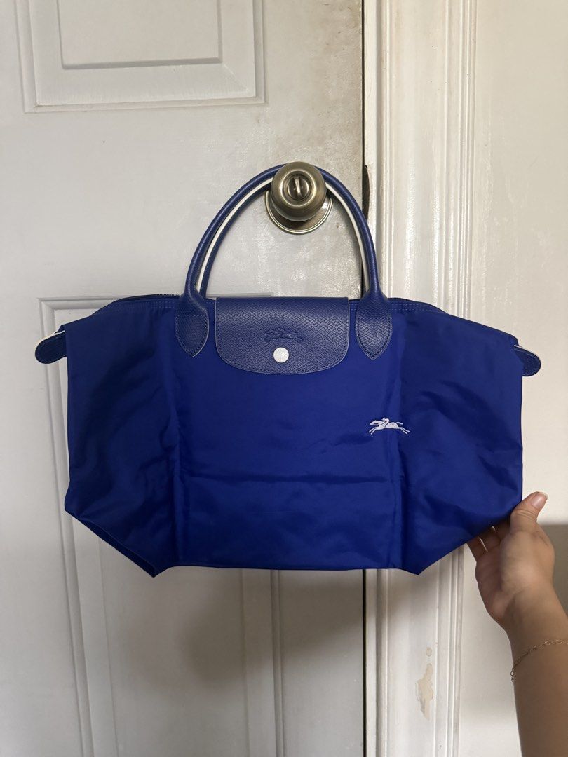 Longchamp Bag (Category: Shoulder Bags) located in Pasig City. Submitted by shopaholic1113 (Listing ID 1458885653, Image 2). Description: - Longchamp Medium Size Short handle tote bag - With stain at the back of the bag (see attached photo for reference) .