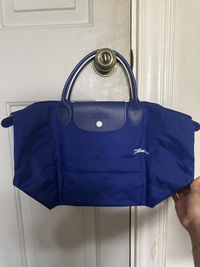Longchamp Bag (Category: Shoulder Bags) located in Pasig City. Submitted by shopaholic1113 (Listing ID 1458885653, Image 1). Description: - Longchamp Medium Size Short handle tote bag - With stain at the back of the bag (see attached photo for reference) .