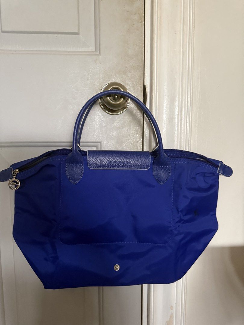 Longchamp Bag (Category: Shoulder Bags) located in Pasig City. Submitted by shopaholic1113 (Listing ID 1458885653, Image 3). Description: - Longchamp Medium Size Short handle tote bag - With stain at the back of the bag (see attached photo for reference) .