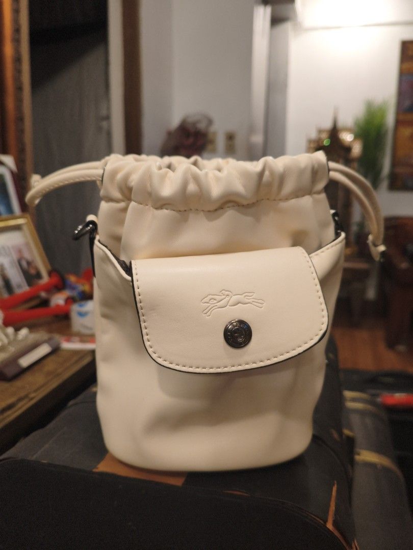 Longchamp Bucket Bag Cream Leather Drawstring (Category: Luxury Bags & Wallets) located in Quezon City. Submitted by ferge88 (Listing ID 1458835854, Image 2). Description: - Cream colored bucket bag - Genuine leather material - Secure drawstring closure - Front flap pocket with iconic Longchamp horse logo - Cute and practical for daily use - Ideal size for carrying your essentials.