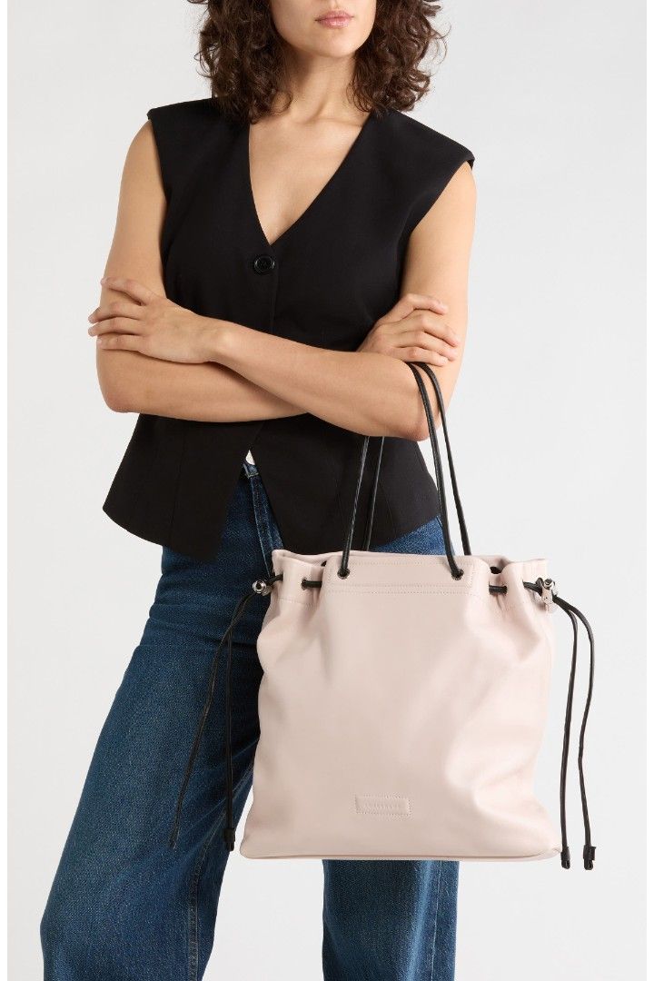 Longchamp Le Roseau Leather Drawstring Tote (Category: Luxury Bags & Wallets) located in Las Pinas. Submitted by xtra_stuff (Listing ID 1458728145, Image 3). Description: - Brand: Longchamp - Material: White Leather - Closure: Drawstring with signature toggle details - Includes: Dust bag - Original Retail Price: $640 - Sale Price: $450 - Ideal for: Everyday use.