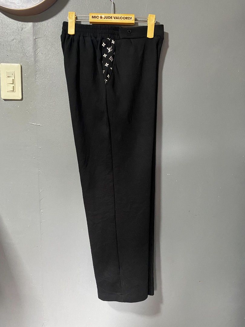 Louis Vuitton Black Monogram Detail Pants (Category: Luxury Apparel) located in Tanay. Submitted by micvalcorza (Listing ID 1458823701, Image 3). Description: - Chic black Trouser pants - Features iconic Louis Vuitton monogram detail on the sides - Comfortable elastic waistband with button closure - Size: Waist 28-30 inches, Length 38 inches - Ideal for casual wear and everyday style - EXCELLENT - 1999 PLUS SHIP.