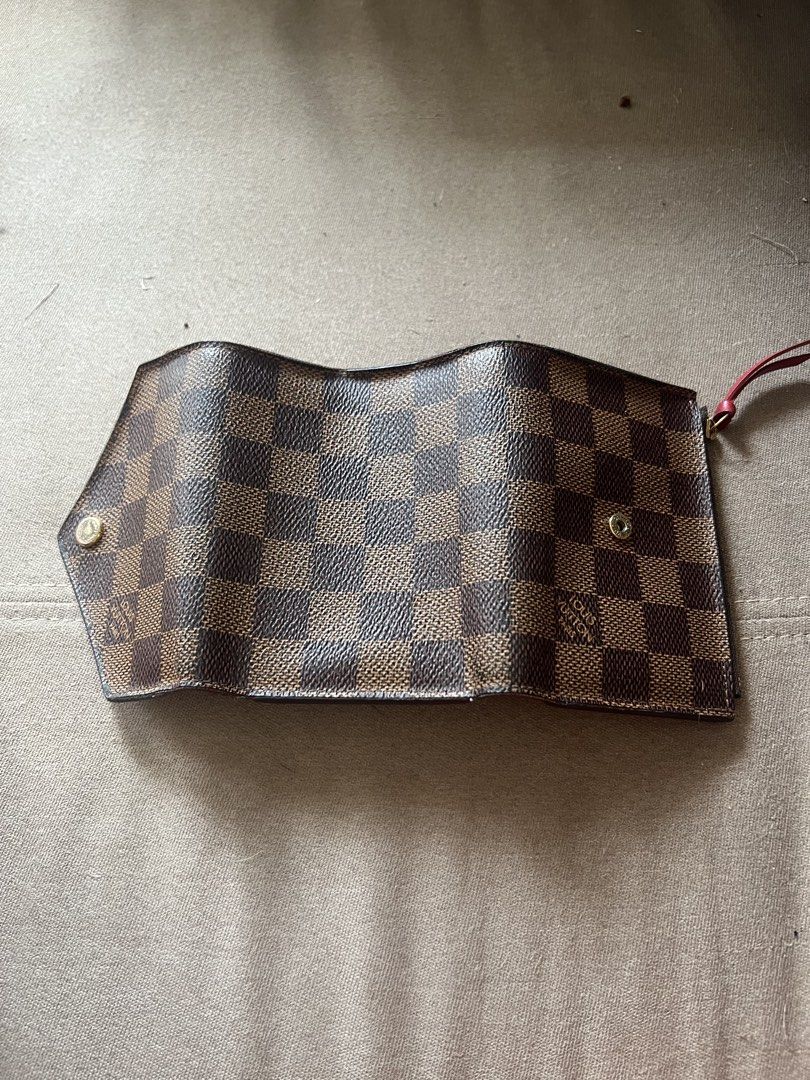 Louis Vuitton Damier Ebene Canvas Tri-fold Wallet (Category: Luxury Bags & Wallets) located in Santa Rosa. Submitted by pepperchill (Listing ID 1458708639, Image 3). Description: - Authentic Louis Vuitton Victorine wallet - Damier Ebene canvas exterior - Red interior - Multiple card slots - Zippered coin pocket - Snap button closure - Classic and essential accessory - 34,500 pa to sa LV website.